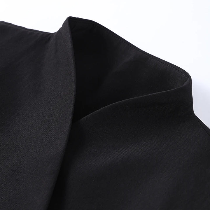 Close-up of black fabric with a subtle texture on a white background