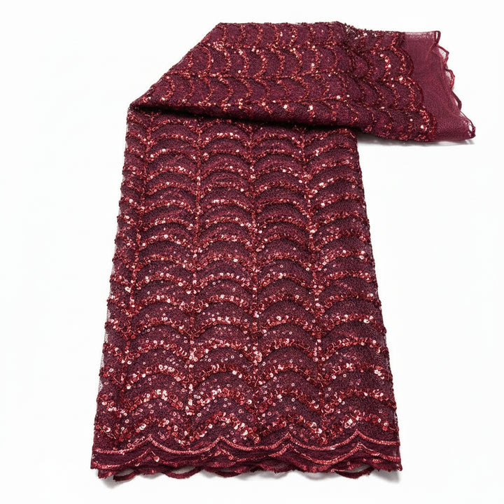 Red glittery fabric with white leaf pattern on a white background