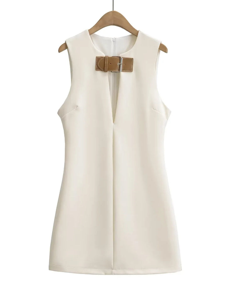 White sleeveless dress with a brown bow on a hanger against a white background