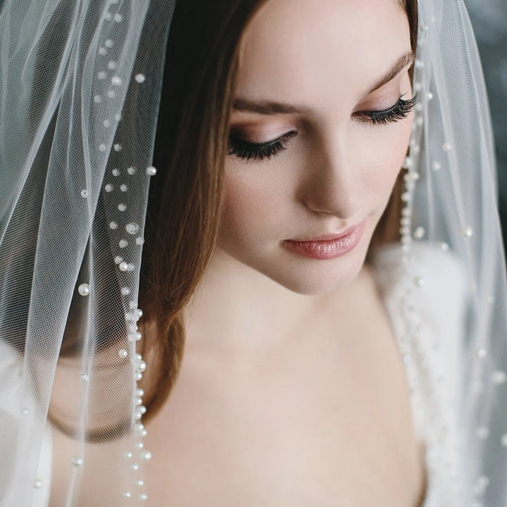 Close-up of a bride wearing a veil with a blurred background