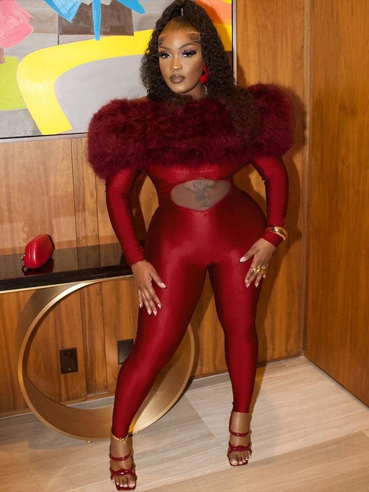 Person wearing a red bodysuit with fur accents in an indoor setting