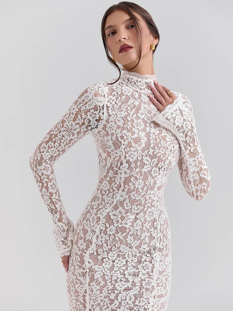 Woman wearing a white lace dress against a light gray background