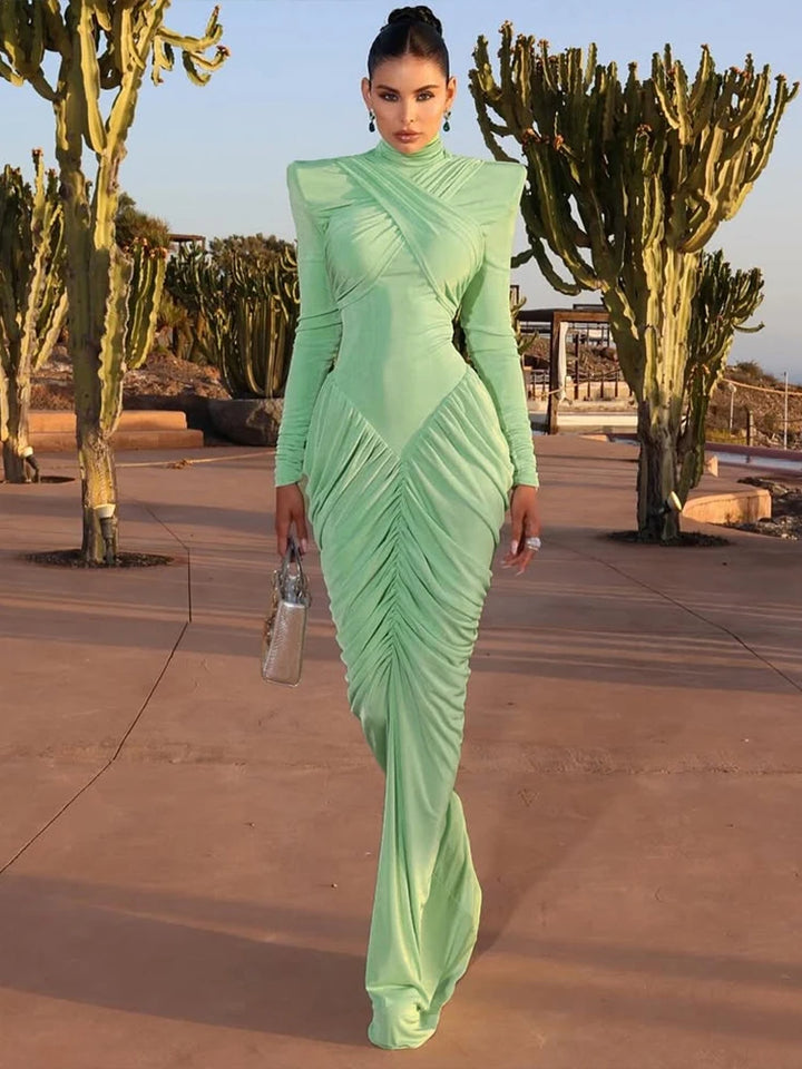 Woman in a green dress standing in front of cacti