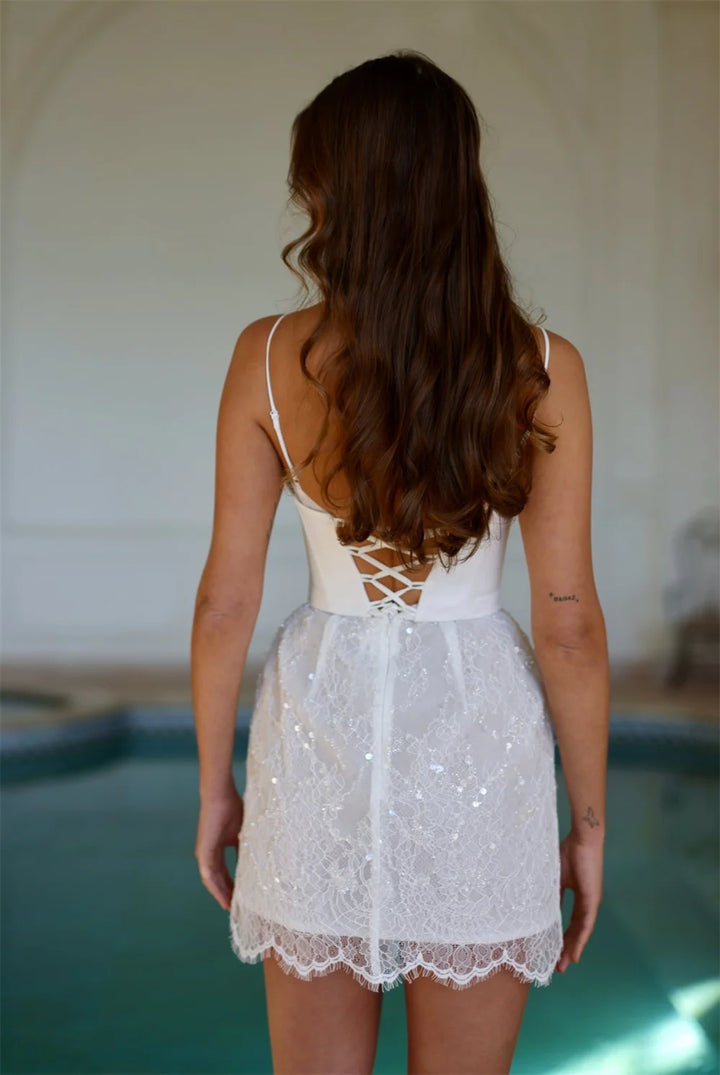 Woman wearing a white lace dress with a blurred background