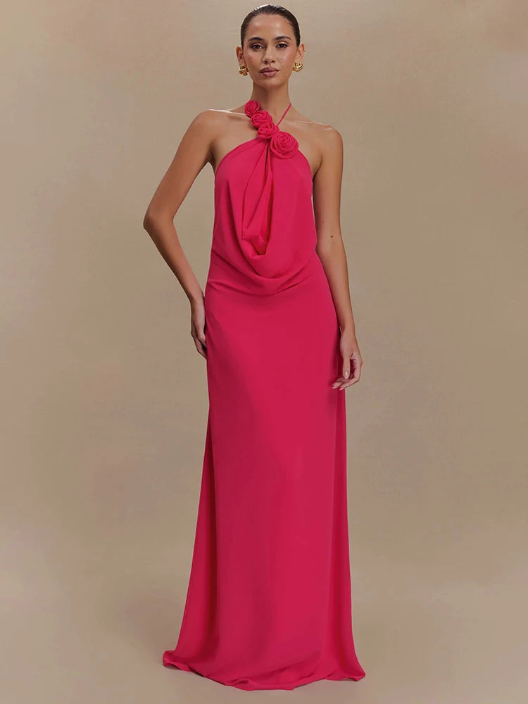 Woman wearing a pink halter neck gown against a beige background