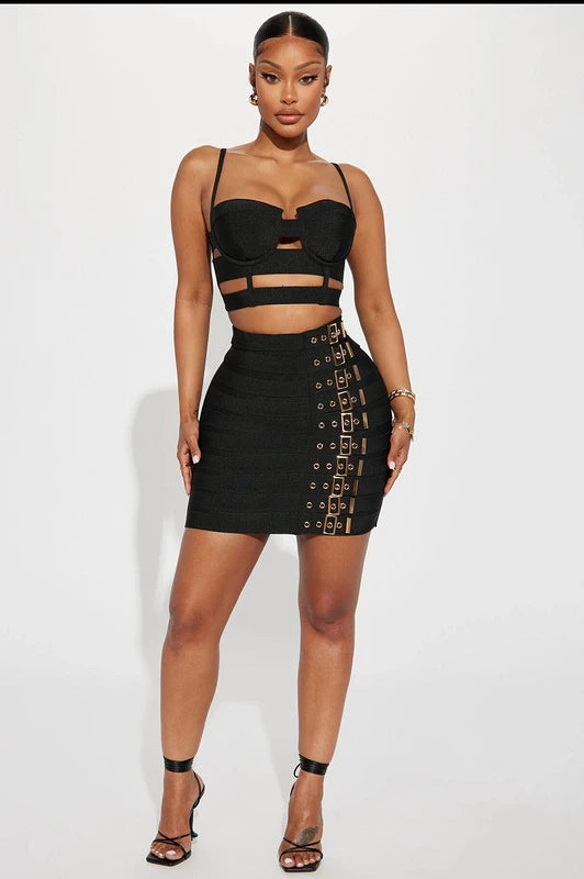 Woman wearing a black outfit with cut-out details on a white background