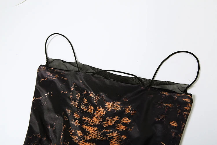 Woman in a leopard print dress standing on a staircase