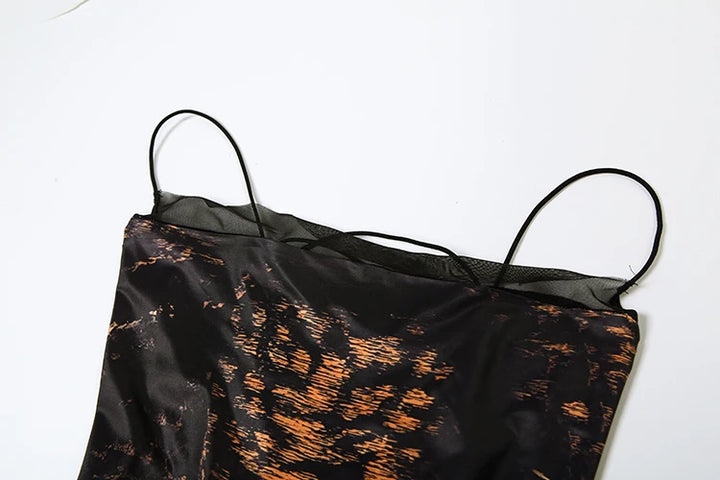 Woman in a leopard print dress standing on a staircase