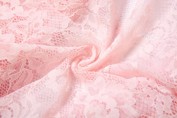 Close-up of pink lace fabric with a soft texture