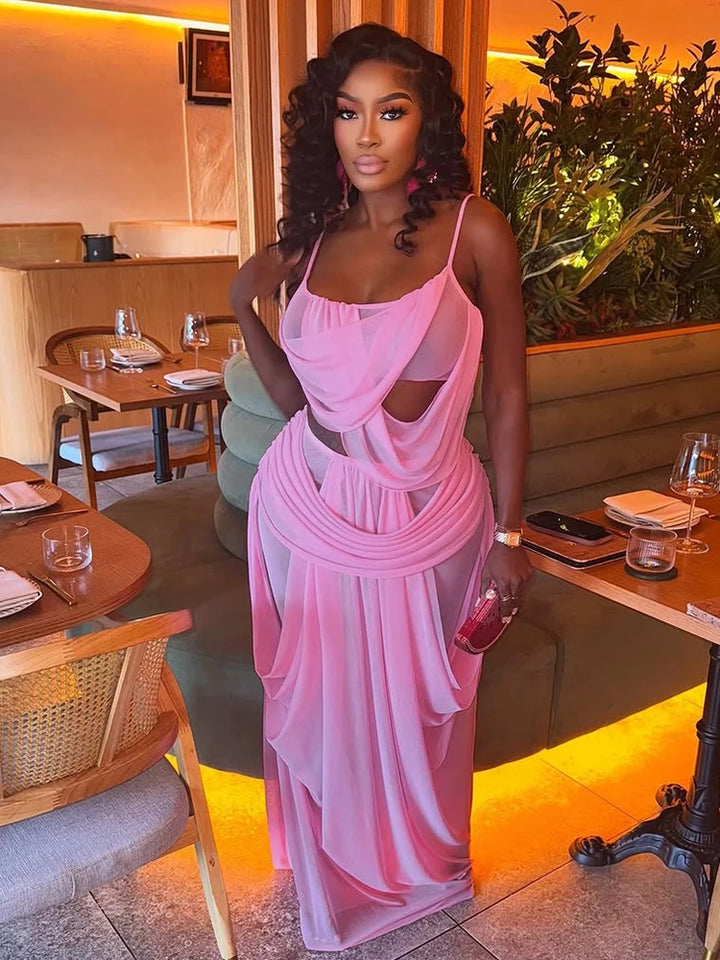 Woman in a pink dress standing in a restaurant setting