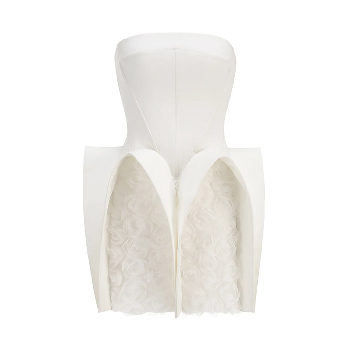 White strapless dress with textured bodice on a white background