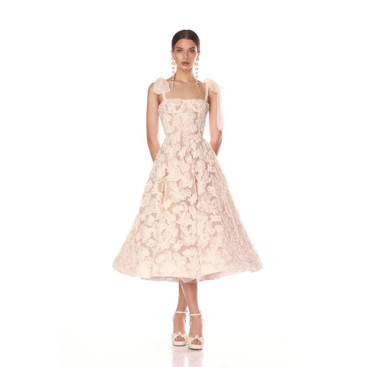 Woman wearing a pink lace dress on a white background