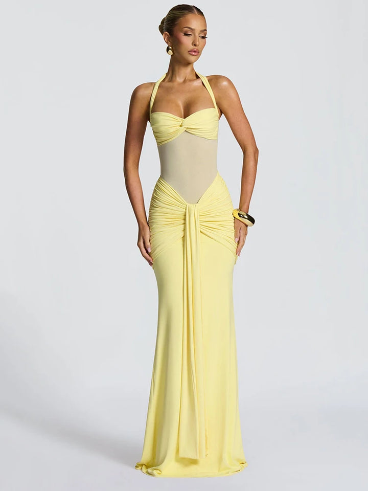Woman wearing a yellow evening gown on a white background