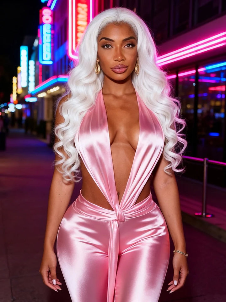 Person wearing a pink satin outfit with neon lights in the background