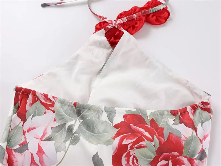 White bikini top with red and gray floral patterned bottom on a white background