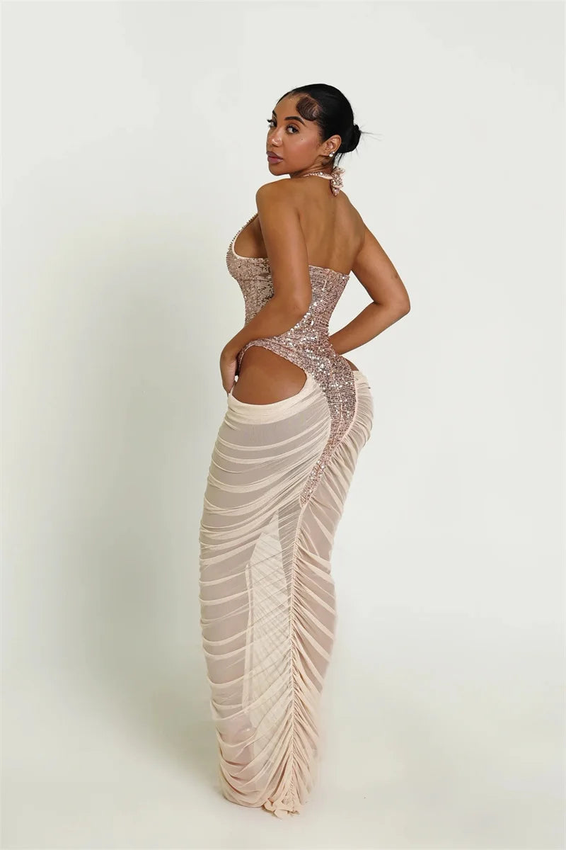 Woman wearing a sparkly, form-fitting dress with cut-out design on a white background