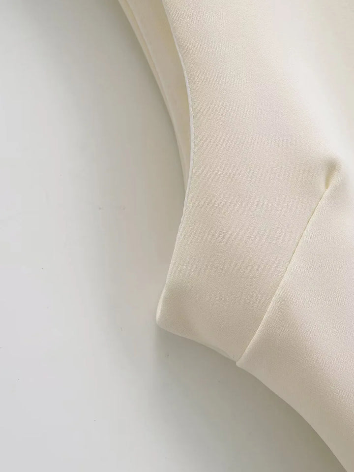 Close-up of a beige fabric texture on a light gray background