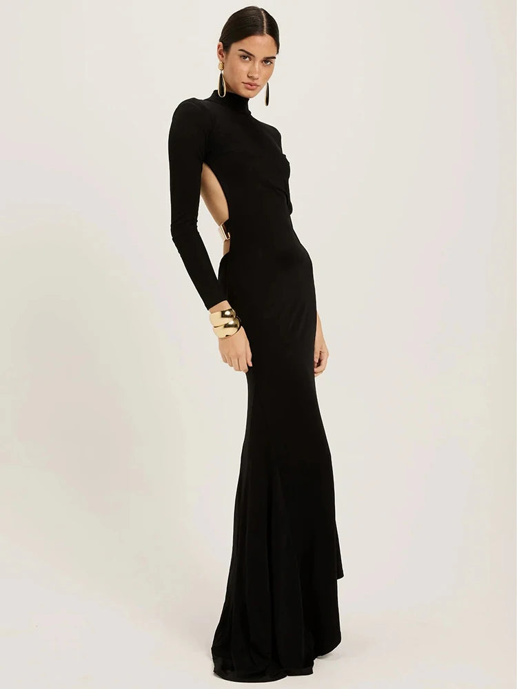  Black Maxi Dress combines sophisticated elegance with contemporary edge. This striking black gown features a high half-collar neckline and form-fitting bodycon silhouette that flatters your figure, while the dramatic backless design creates an unforgettable statement. 