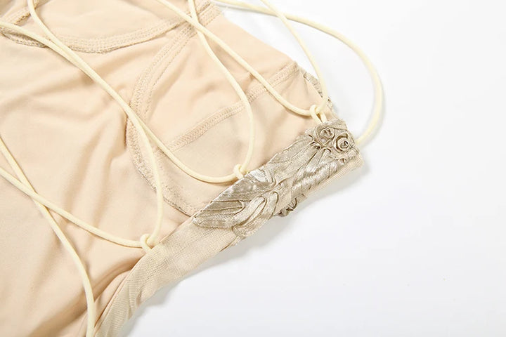 Beige bikini with floral details on a white background