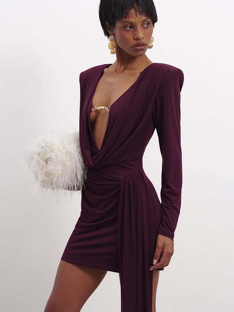 Woman wearing a burgundy dress with long sleeves on a white background