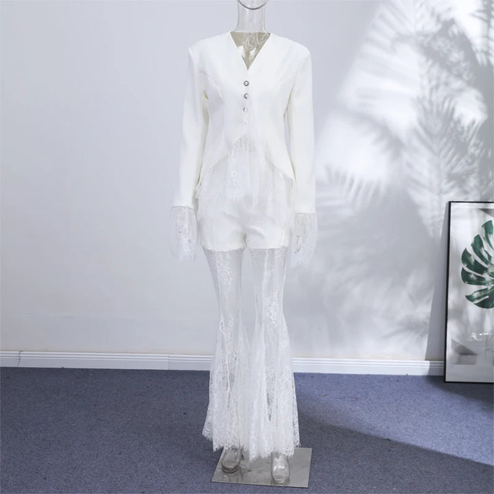 Mannequin wearing a white outfit with lace details against a plain wall.