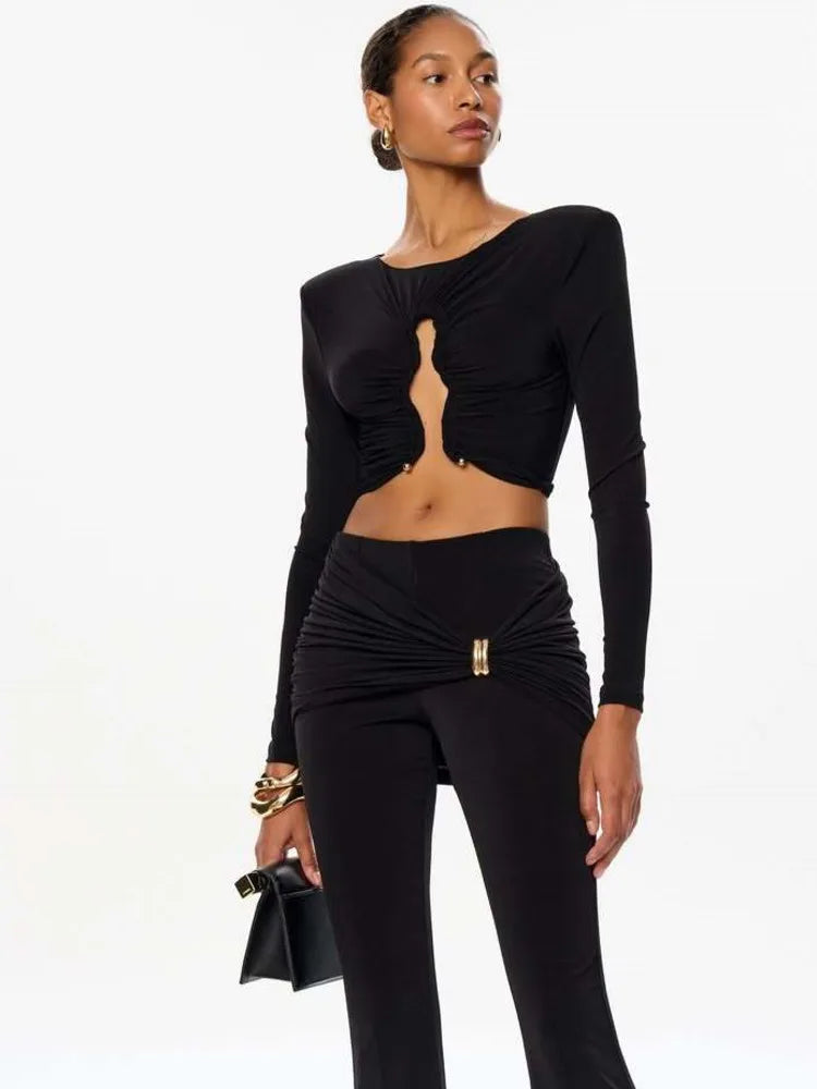 Woman wearing a black outfit with cut-out design on a white background