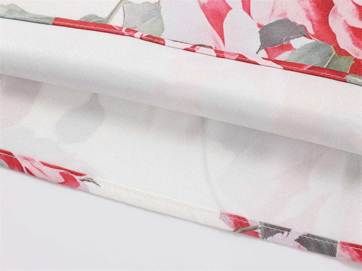 Floral fabric with red, white, and gray pattern on a white background