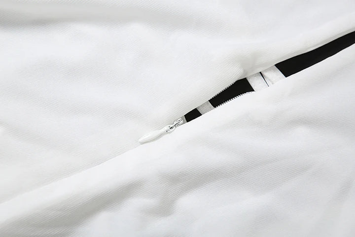 Close-up of a white fabric with a black and silver belt on a white background