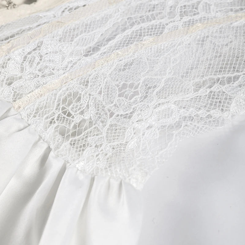 Close-up of a white lace trim on a white fabric background