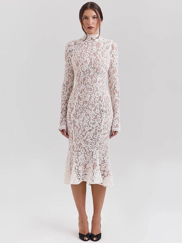 Woman wearing a white lace dress on a light gray background