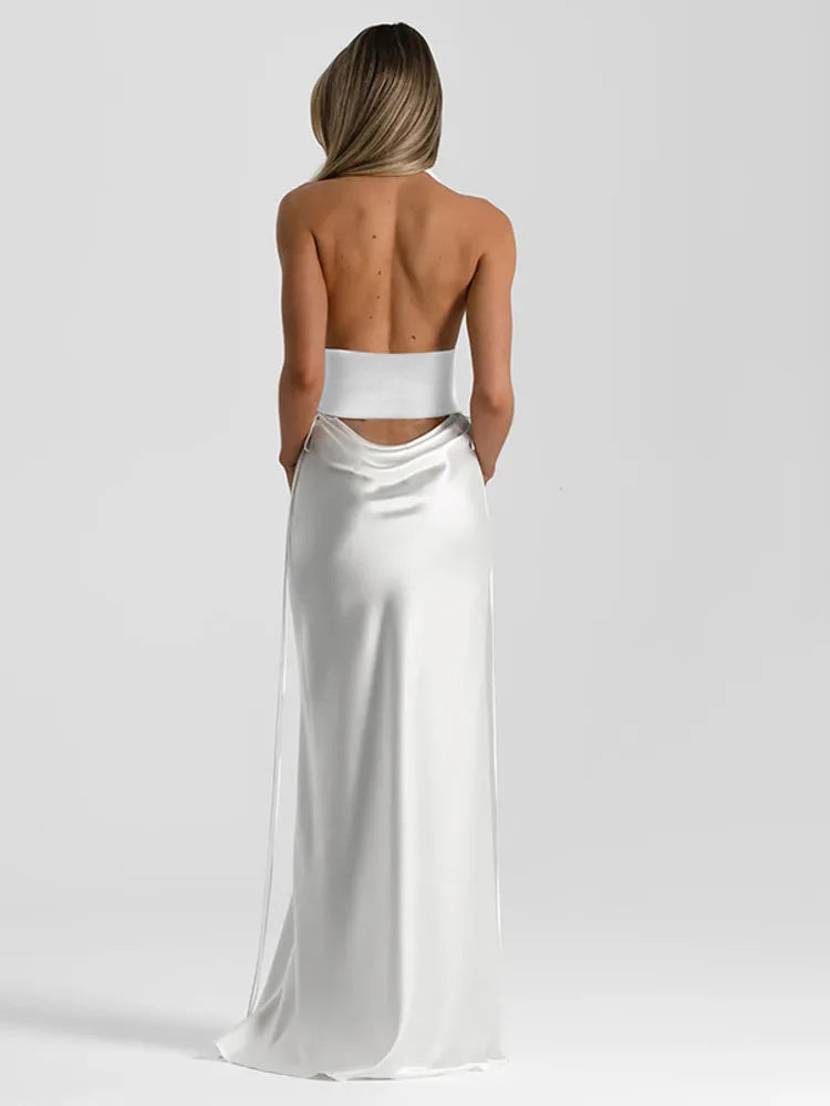 Woman wearing a white strapless gown on a plain background