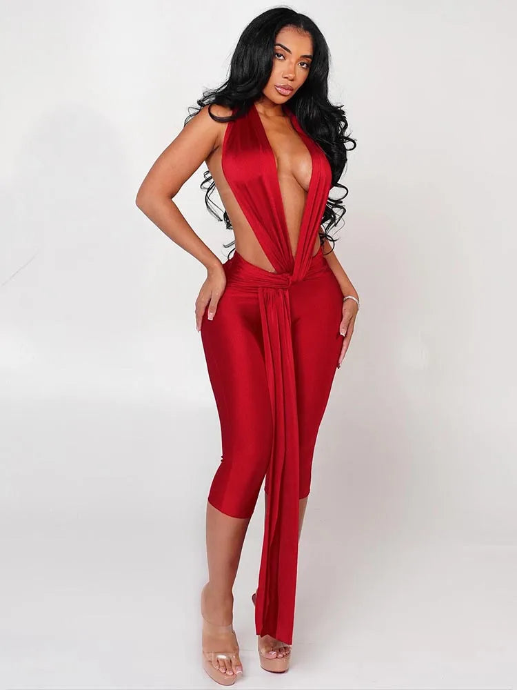 Woman wearing a red jumpsuit with cut-out design on a white background