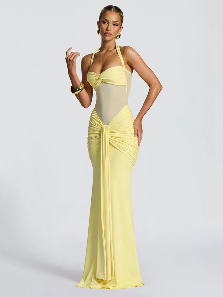 Woman wearing a yellow evening gown on a light gray background