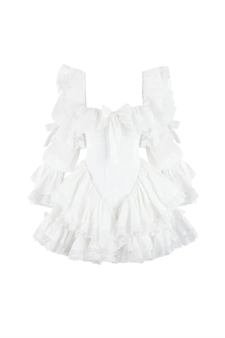 A white ruffled babydoll-style romper with a bow at the chest and layered ruffle details, shown against a plain white background.