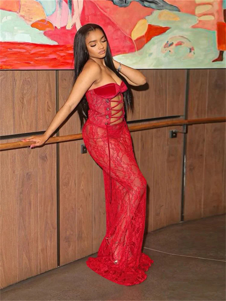 Woman in a red dress standing against a colorful mural.