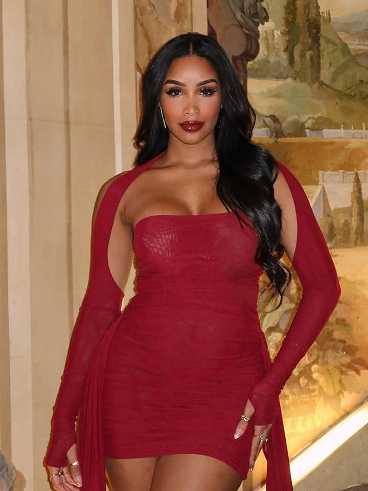 Woman wearing a red dress with long sleeves in an indoor setting