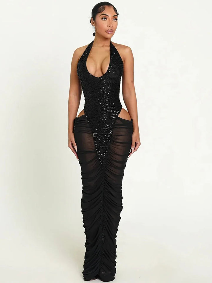 Black sequin dress with sheer panels on a white background