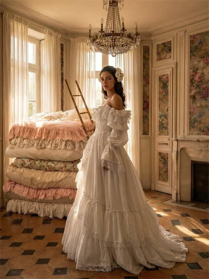 Woman in a white dress standing in a vintage room with a chandelier and floral decor.