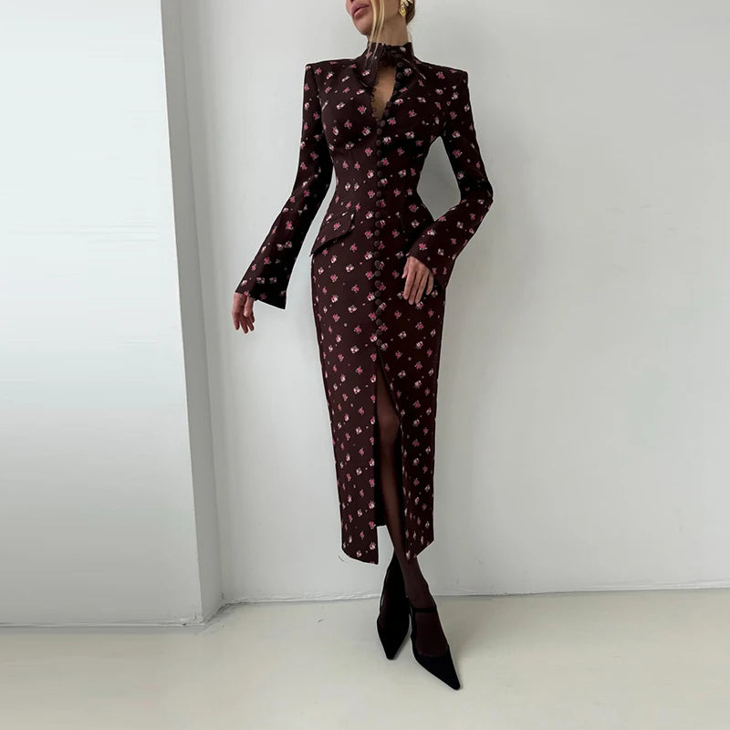 Woman wearing a patterned dress with long sleeves and a slit on a white background
