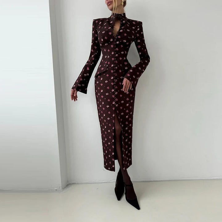 Woman wearing a patterned dress with long sleeves and a slit on a white background