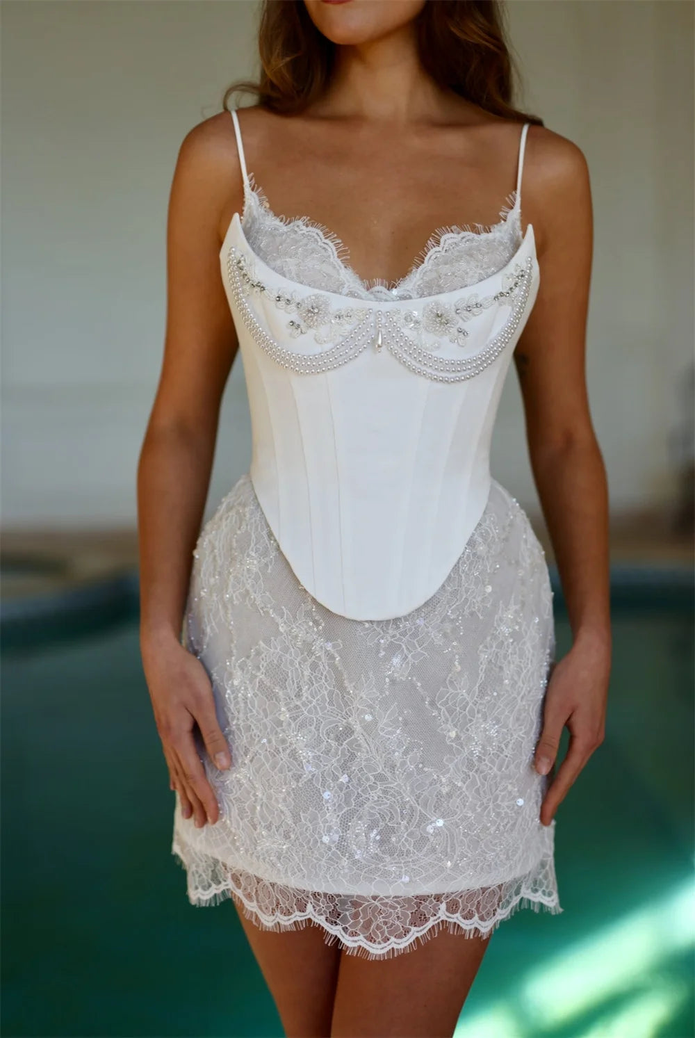White lace nightgown worn by a person with a blurred background