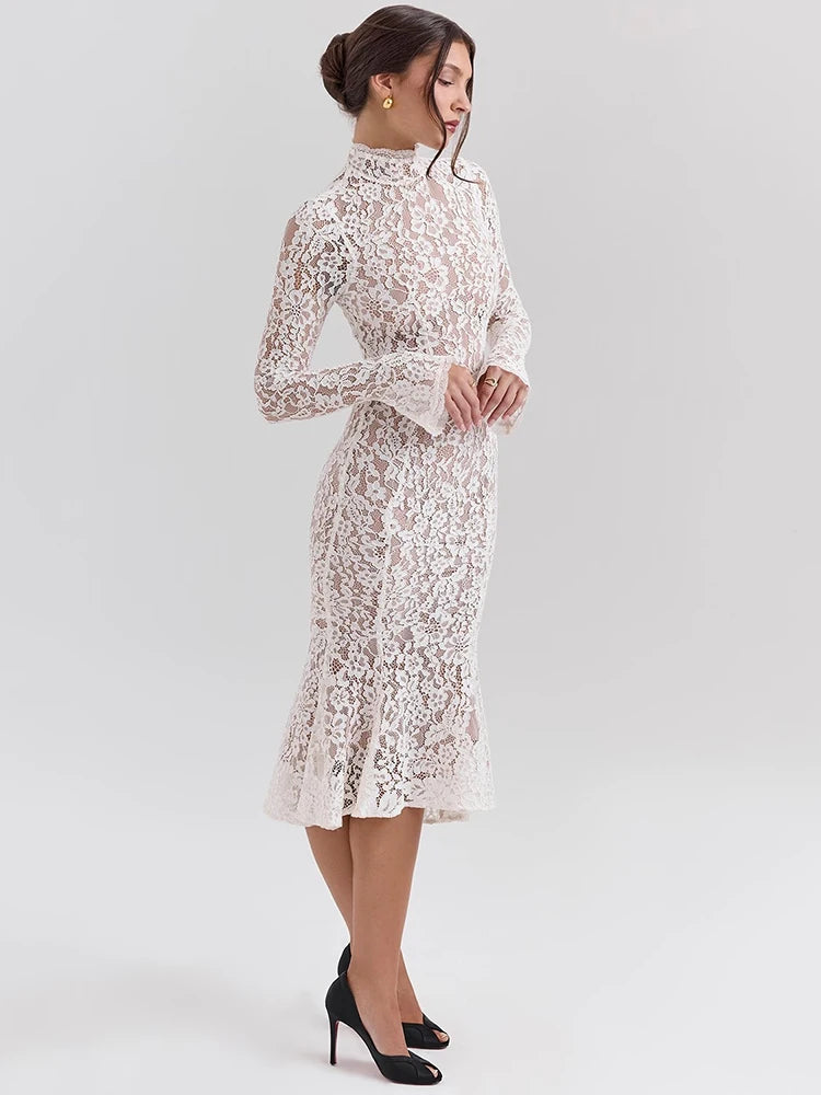 Woman wearing a white lace dress on a light gray background