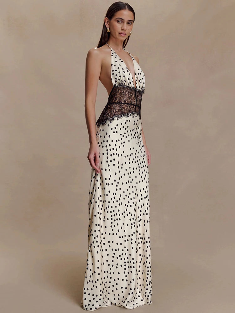 Woman wearing a polka dot evening gown with lace details on a beige background