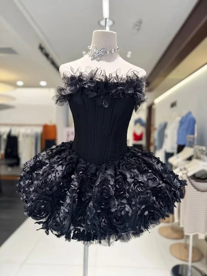 Black floral dress on a mannequin in a store setting