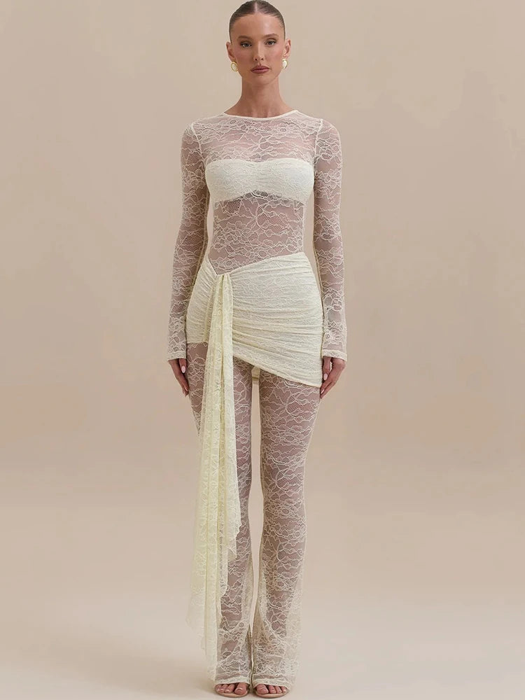 Model wearing a sheer long-sleeve top and pants with a white skirt on a beige background