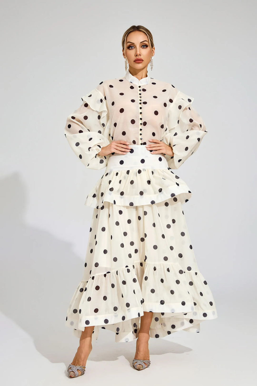 Woman wearing a polka dot outfit on a white background