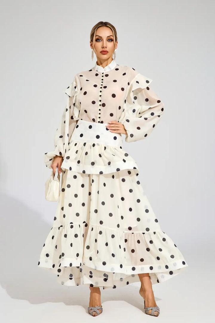 Woman wearing a polka dot outfit with a white background